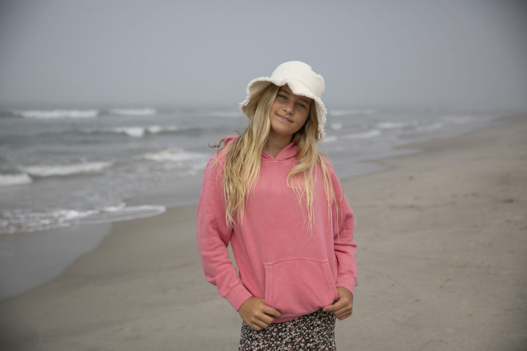 smiling young girl wears summer hat