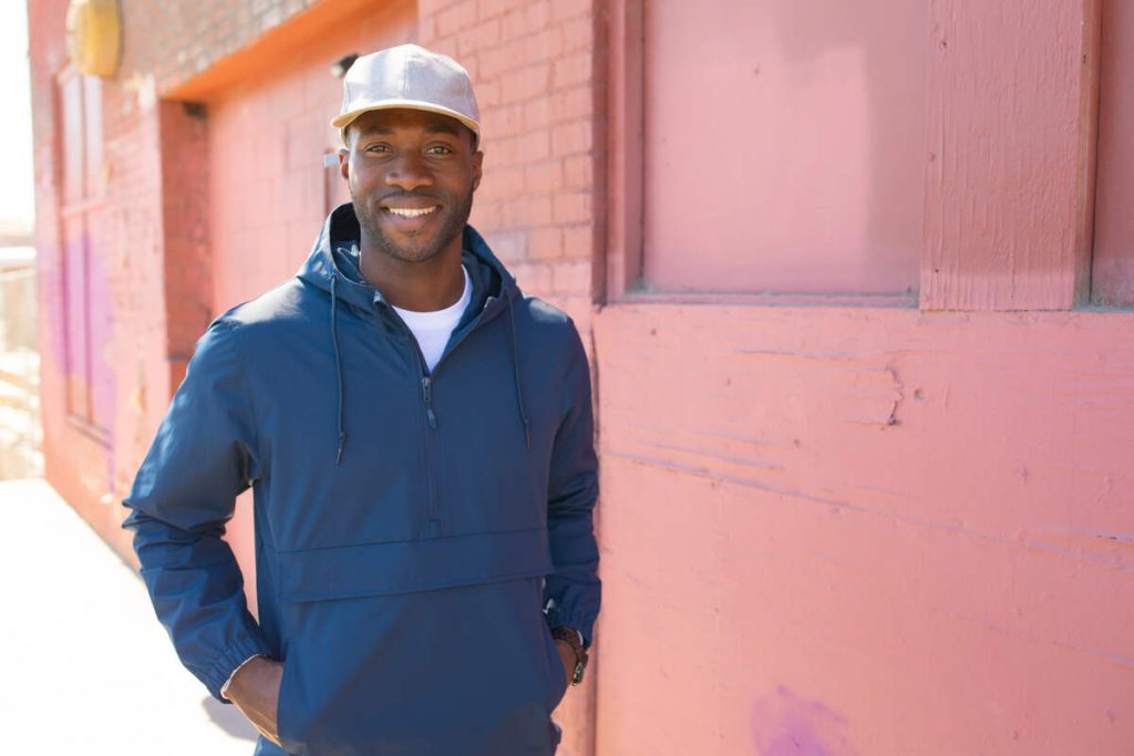 smiling man wears dad hat