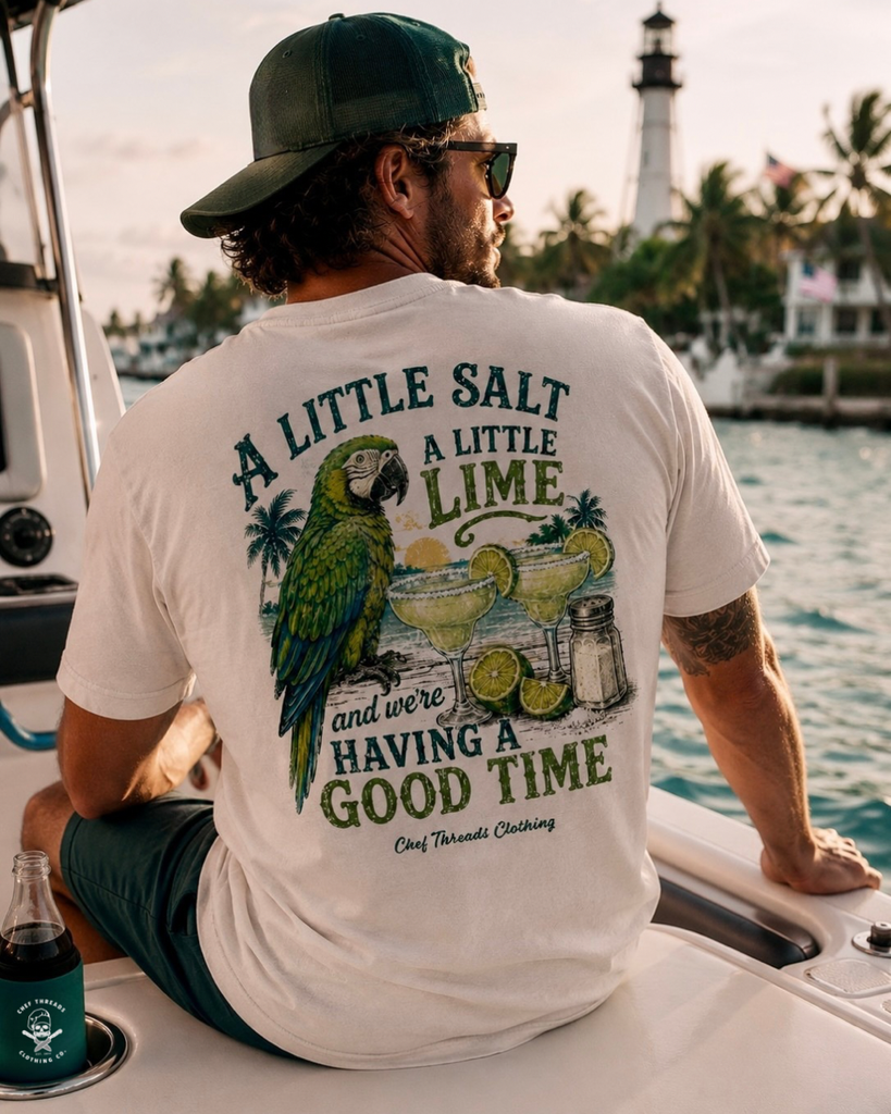 Man on a boat in a custom pigment-dyed tee with a parrot and margarita print by Chef Threads, made with Apliiq