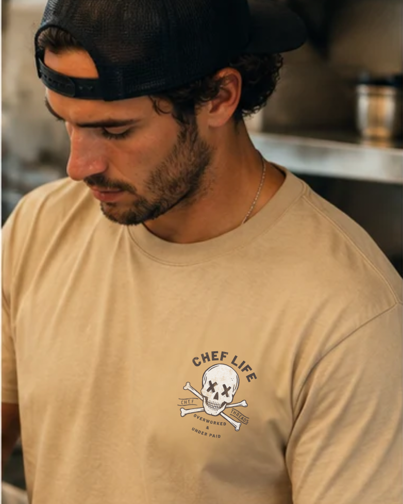 Chef in a custom Next Level tee with a Chef Life skull print from Chef Threads, made with Apliiq