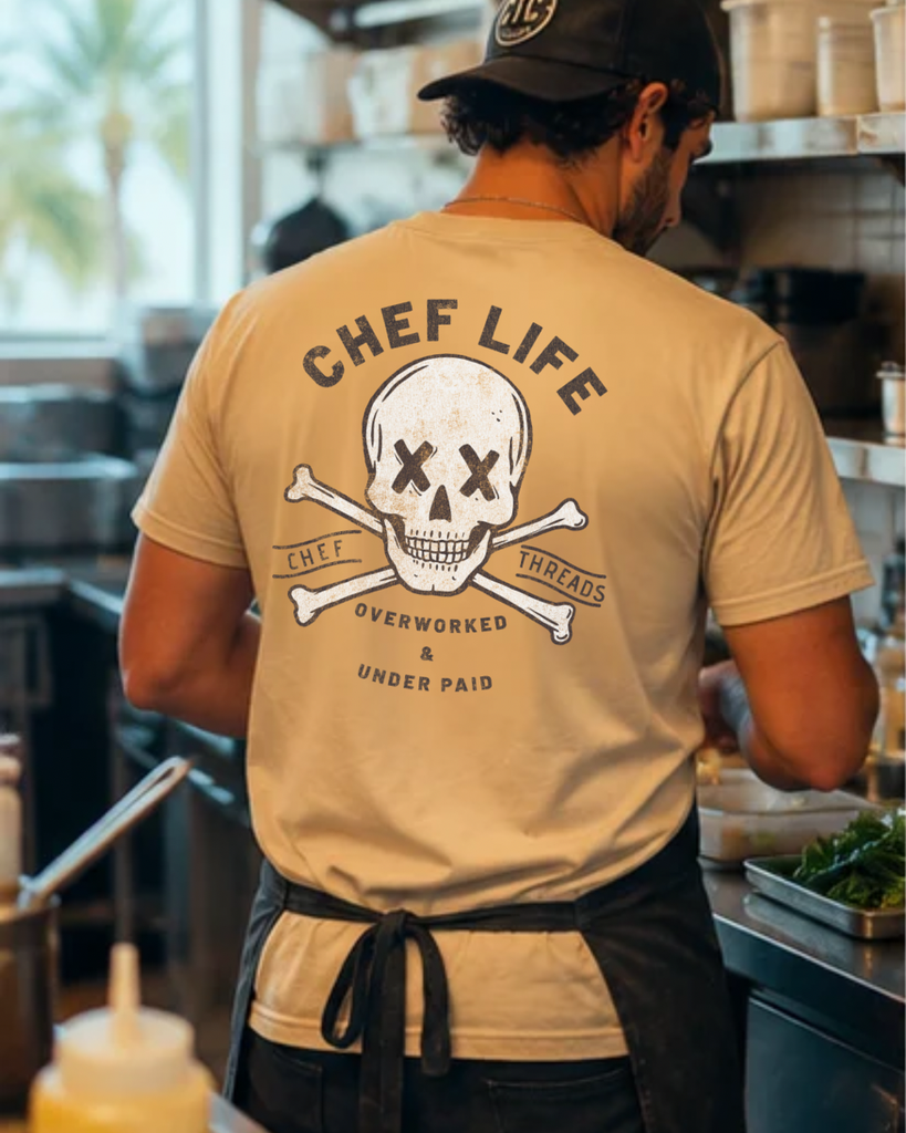 Back of a custom Chef Life skull tee on a cook in an apron, Chef Threads custom apparel made with Apliiq